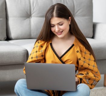 full-shot-smiley-woman-holding-laptop